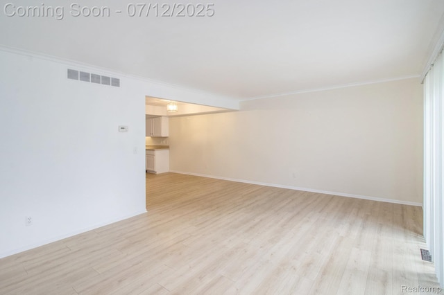 7924 Meadow Dr, Waterford, MI 48329 - empty room featuring crown molding and light wood finished floors