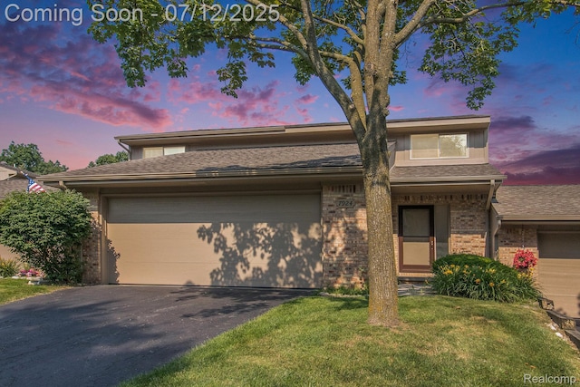 7924 Meadow Dr, Waterford, MI 48329 - view of front of house featuring brick siding, a garage, driveway, a lawn, and roof with shingles