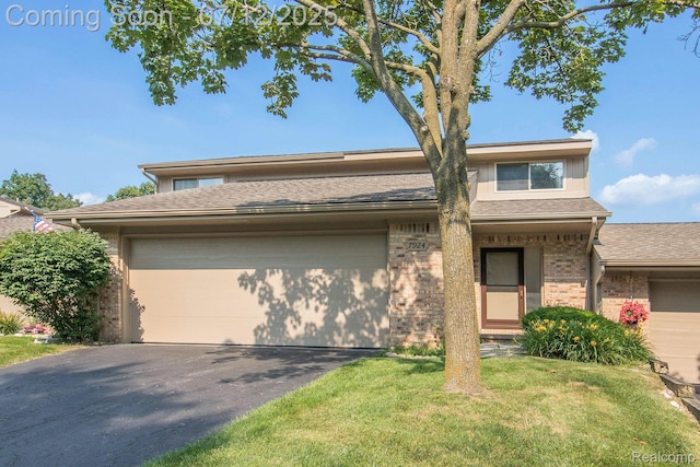 7924 Meadow Dr, Waterford, MI 48329 - view of front of house with brick siding, a garage, a front lawn, asphalt driveway, and roof with shingles