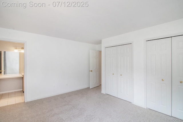 7924 Meadow Dr, Waterford, MI 48329 - unfurnished bedroom with multiple closets, carpet floors, and ensuite bath