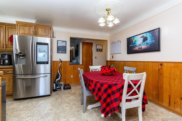 8345 E 14 Mile Rd, Sterling Heights, MI 48312 - dining space with wainscoting, wood walls, and a chandelier