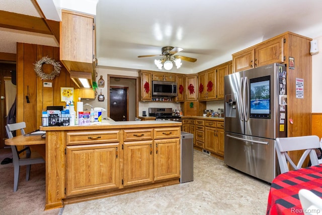 8345 E 14 Mile Rd, Sterling Heights, MI 48312 - kitchen with stainless steel appliances, a peninsula, ceiling fan, brown cabinets, and light countertops