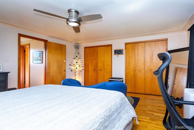 8345 E 14 Mile Rd, Sterling Heights, MI 48312 - bedroom featuring light wood-style flooring, multiple closets, and a ceiling fan