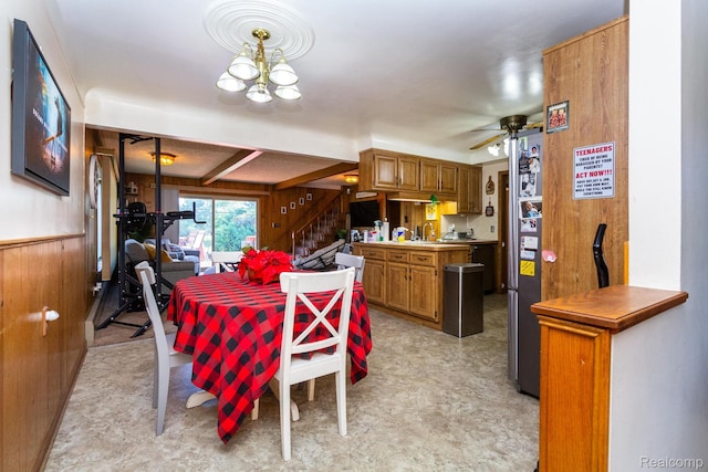 8345 E 14 Mile Rd, Sterling Heights, MI 48312 - dining room with wooden walls, stairway, ceiling fan, a chandelier, and light flooring