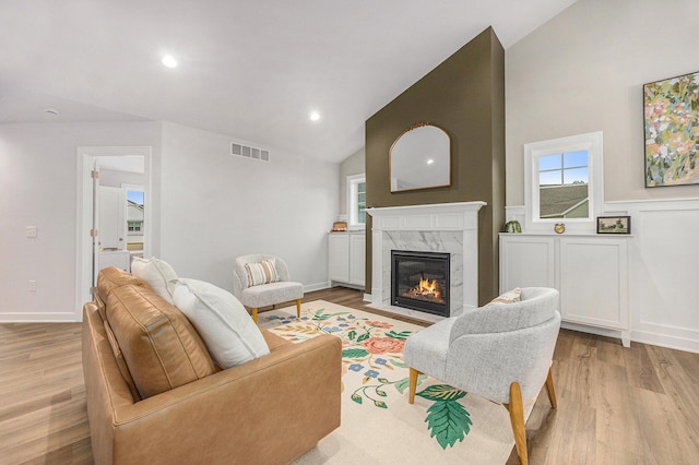 LOT99 Rose Ridge Dr, Rockford, MI 49341 - living area with a high end fireplace, light wood finished floors, high vaulted ceiling, and recessed lighting