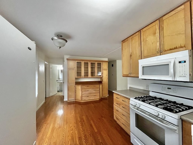 3304 Wanda Ave, Muskegon, MI 49442 - kitchen with white appliances, dark wood-type flooring, glass insert cabinets, light brown cabinetry, and light countertops