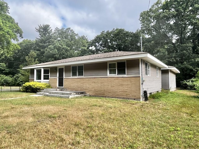 3304 Wanda Ave, Muskegon, MI 49442 - view of front of property with brick siding, a front lawn, and crawl space