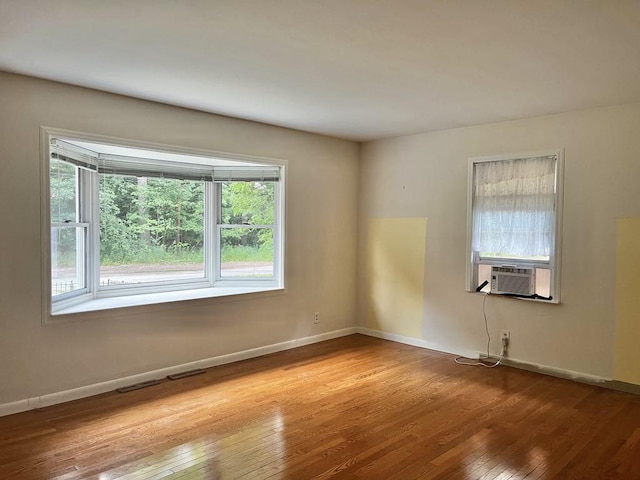 3304 Wanda Ave, Muskegon, MI 49442 - unfurnished room featuring hardwood / wood-style floors and cooling unit