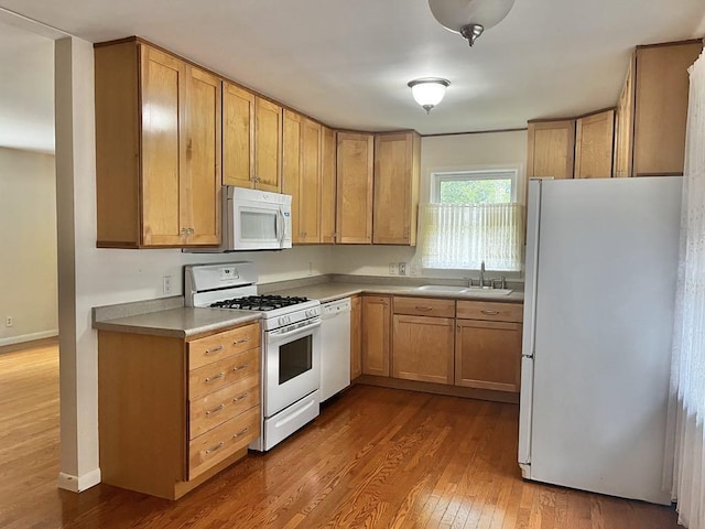 3304 Wanda Ave, Muskegon, MI 49442 - kitchen featuring white appliances, dark wood-style floors, and light countertops