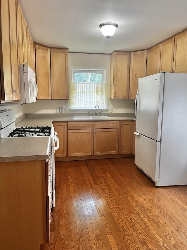 3304 Wanda Ave, Muskegon, MI 49442 - kitchen with white appliances, dark wood-type flooring, light brown cabinetry, and light countertops