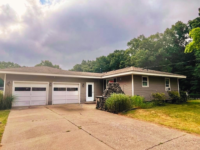 3304 Wanda Ave, Muskegon, MI 49442 - view of front of home with concrete driveway, a garage, and a front lawn