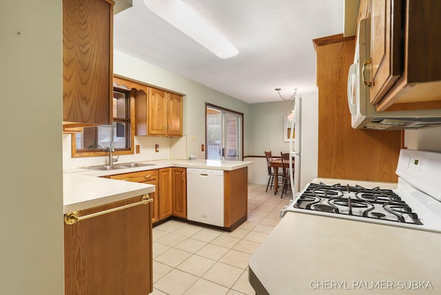 1838 Kings Ct, Muskegon, MI 49445 - kitchen featuring white appliances, a peninsula, light tile patterned floors, light countertops, and brown cabinetry