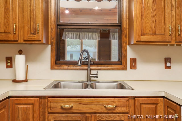 1838 Kings Ct, Muskegon, MI 49445 - kitchen featuring brown cabinets and light countertops
