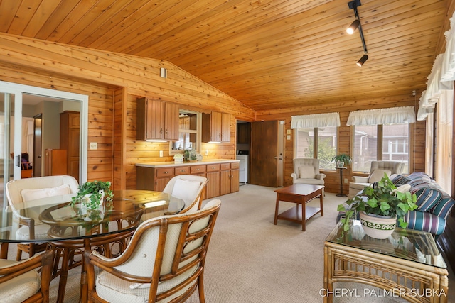 1838 Kings Ct, Muskegon, MI 49445 - dining space featuring lofted ceiling, wood walls, track lighting, wood ceiling, and light carpet