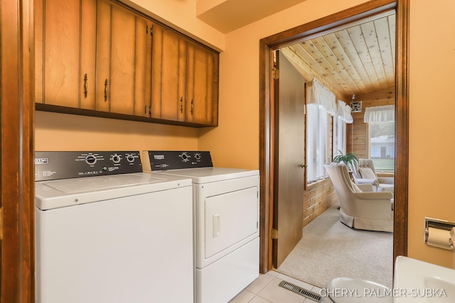 1838 Kings Ct, Muskegon, MI 49445 - laundry area with separate washer and dryer, cabinet space, light carpet, light tile patterned flooring, and wooden ceiling