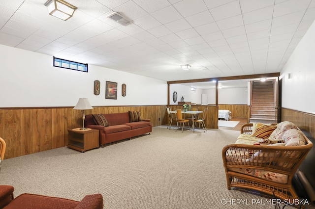 1838 Kings Ct, Muskegon, MI 49445 - carpeted living room featuring wainscoting and wooden walls