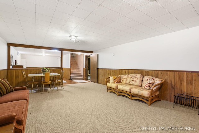 1838 Kings Ct, Muskegon, MI 49445 - living room with wainscoting, wood walls, carpet flooring, and stairs