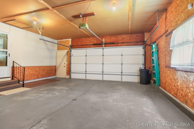 1838 Kings Ct, Muskegon, MI 49445 - garage featuring a garage door opener and baseboards