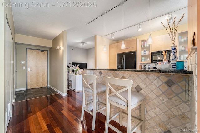 432 S Washington Ave Unit 802, Royal Oak, MI 48067 - kitchen featuring black appliances, dark countertops, dark wood-type flooring, glass insert cabinets, and a peninsula