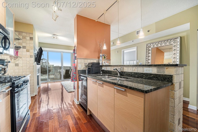 432 S Washington Ave Unit 802, Royal Oak, MI 48067 - kitchen featuring black gas range, rail lighting, dark wood-type flooring, and dark stone countertops