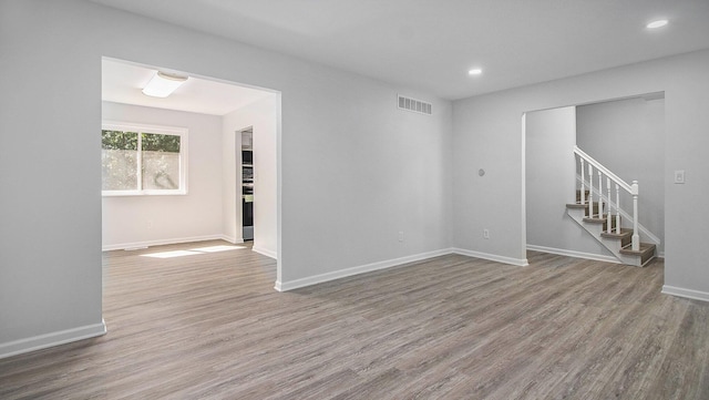 1796 Norfolk Ave, Ypsilanti, MI 48198 - empty room featuring wood finished floors, stairway, and recessed lighting