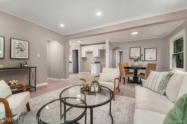 6031 Grandville Ave, Dearborn, MI 48228 - living area with arched walkways, light wood-type flooring, and recessed lighting