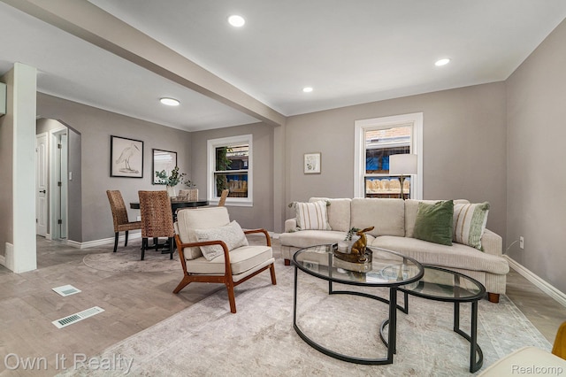 6031 Grandville Ave, Dearborn, MI 48228 - living area featuring arched walkways, light wood-style flooring, and recessed lighting
