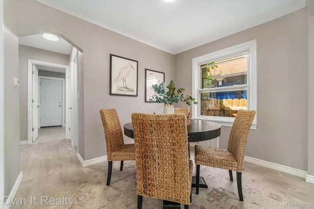 6031 Grandville Ave, Dearborn, MI 48228 - dining area with light wood-style floors and arched walkways