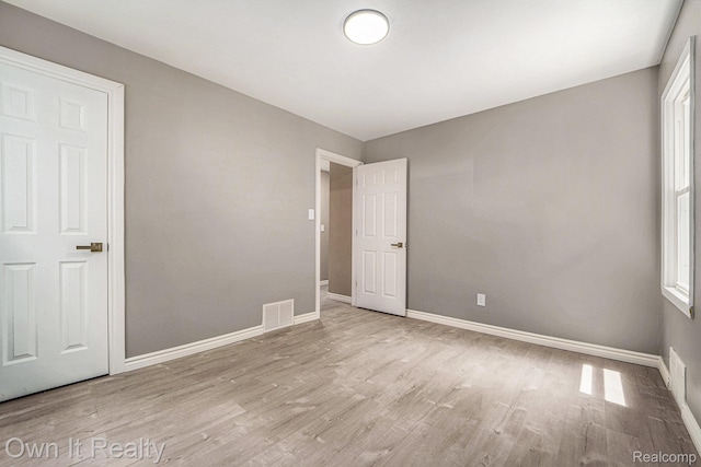 6031 Grandville Ave, Dearborn, MI 48228 - spare room with wood finished floors and healthy amount of natural light