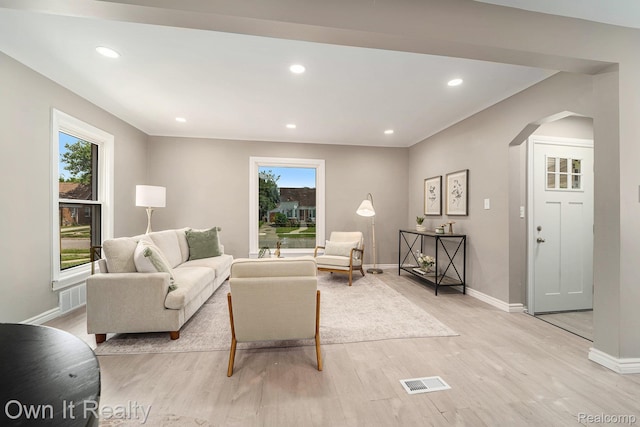 6031 Grandville Ave, Dearborn, MI 48228 - living area with arched walkways, light wood-style flooring, and recessed lighting