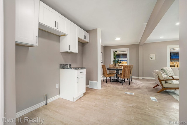 6031 Grandville Ave, Dearborn, MI 48228 - kitchen with light wood-style floors, white cabinetry, recessed lighting, and dark stone counters