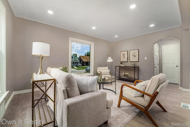 6031 Grandville Ave, Dearborn, MI 48228 - living room with light wood-type flooring, arched walkways, and recessed lighting