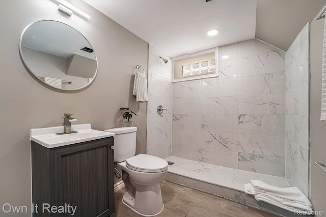 6031 Grandville Ave, Dearborn, MI 48228 - bathroom featuring vanity, tiled shower, wood finished floors, and recessed lighting