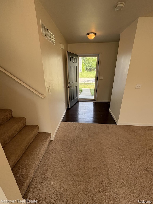 8213 Bayberry Ct, Dexter, MI 48130 - foyer entrance with dark colored carpet and stairs