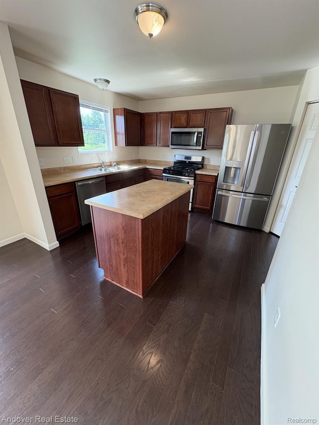 8213 Bayberry Ct, Dexter, MI 48130 - kitchen featuring appliances with stainless steel finishes, light countertops, dark wood-style floors, and a kitchen island