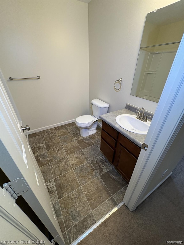 8213 Bayberry Ct, Dexter, MI 48130 - bathroom featuring vanity and stone finish floors