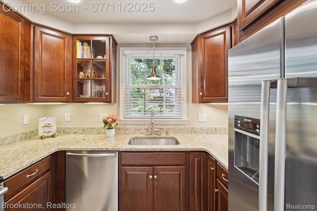 2351 Earlmont Rd, Berkley, MI 48072 - kitchen with appliances with stainless steel finishes, glass insert cabinets, light stone countertops, and decorative light fixtures