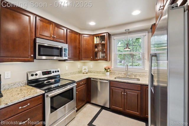 2351 Earlmont Rd, Berkley, MI 48072 - kitchen featuring appliances with stainless steel finishes, glass insert cabinets, light stone countertops, decorative light fixtures, and recessed lighting
