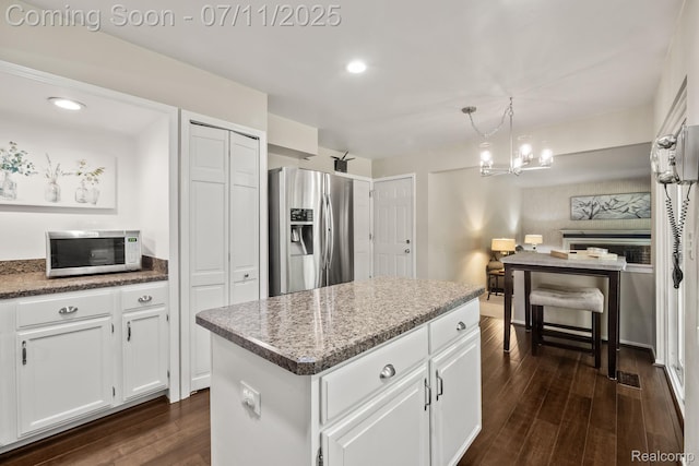 2686 Orbit Dr, Lake Orion, MI 48360 - kitchen featuring stainless steel appliances, dark wood-type flooring, white cabinetry, a center island, and recessed lighting