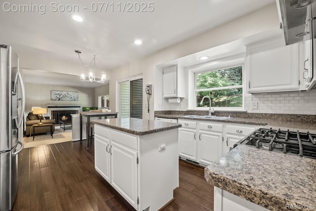 2686 Orbit Dr, Lake Orion, MI 48360 - kitchen with stainless steel fridge with ice dispenser, dark wood finished floors, a kitchen island, recessed lighting, and a chandelier