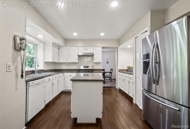 2686 Orbit Dr, Lake Orion, MI 48360 - kitchen featuring appliances with stainless steel finishes, a kitchen island, white cabinets, dark wood-type flooring, and dark stone counters