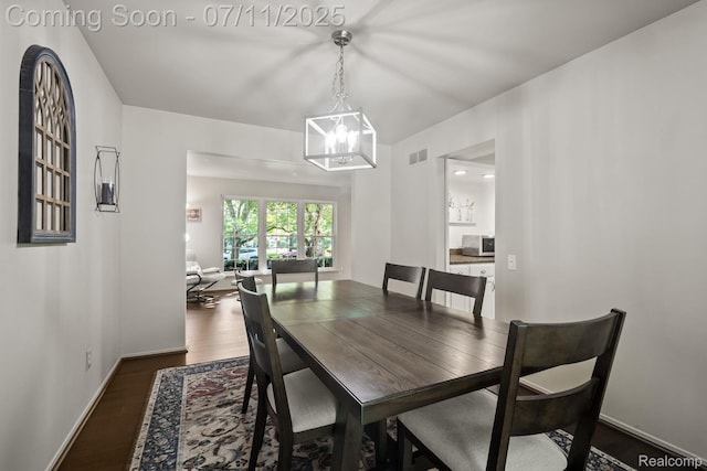 2686 Orbit Dr, Lake Orion, MI 48360 - dining room with dark wood-type flooring and a chandelier