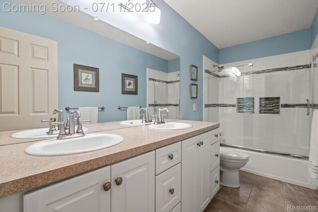 2686 Orbit Dr, Lake Orion, MI 48360 - bathroom featuring double vanity, shower / bath combination with glass door, and tile patterned floors