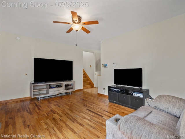 2553 Koper Dr, Macomb, MI 48310 - living area with ceiling fan, stairway, and light wood-style floors