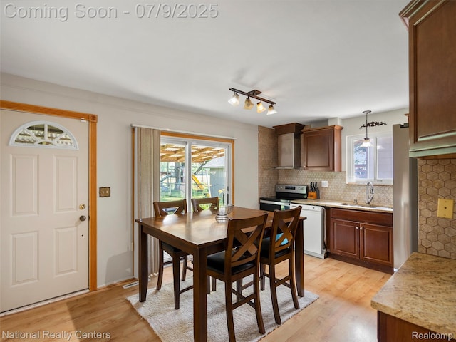 2553 Koper Dr, Macomb, MI 48310 - dining room with light wood-style floors and healthy amount of natural light
