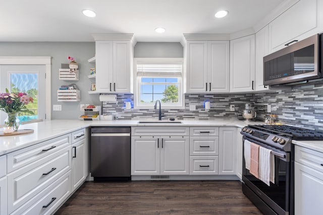 10501 Somerset Rd, Cement City, MI 49233 - kitchen with appliances with stainless steel finishes, backsplash, white cabinets, recessed lighting, and dark wood finished floors