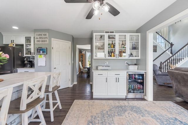 10501 Somerset Rd, Cement City, MI 49233 - kitchen featuring freestanding refrigerator, wine cooler, dark wood-type flooring, glass insert cabinets, and white cabinets