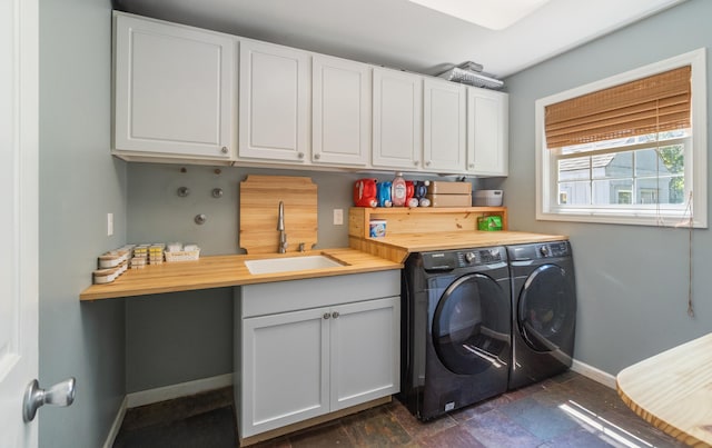 10501 Somerset Rd, Cement City, MI 49233 - laundry area featuring independent washer and dryer, cabinet space, and dark stone finish floors