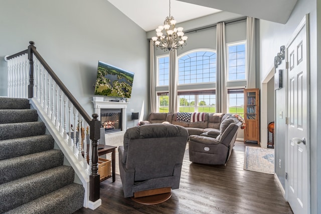 10501 Somerset Rd, Cement City, MI 49233 - living room with a high ceiling, a chandelier, dark wood-style flooring, a fireplace, and stairway