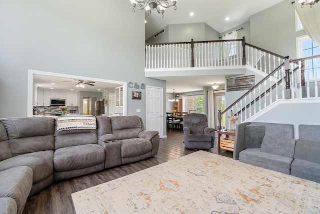 10501 Somerset Rd, Cement City, MI 49233 - living room featuring a chandelier, high vaulted ceiling, wood finished floors, healthy amount of natural light, and stairs